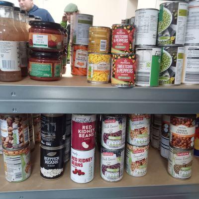 tinned food on shelves in food pantry