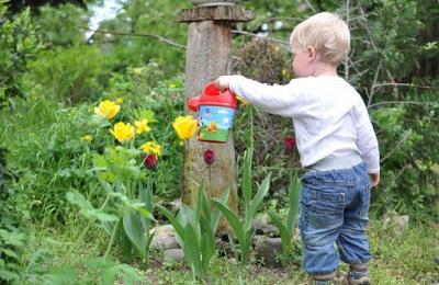 child watering flowers