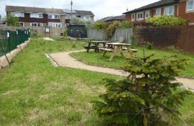 Garden site with picnic benches and gravel path