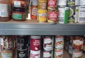tinned food on shelves in food pantry